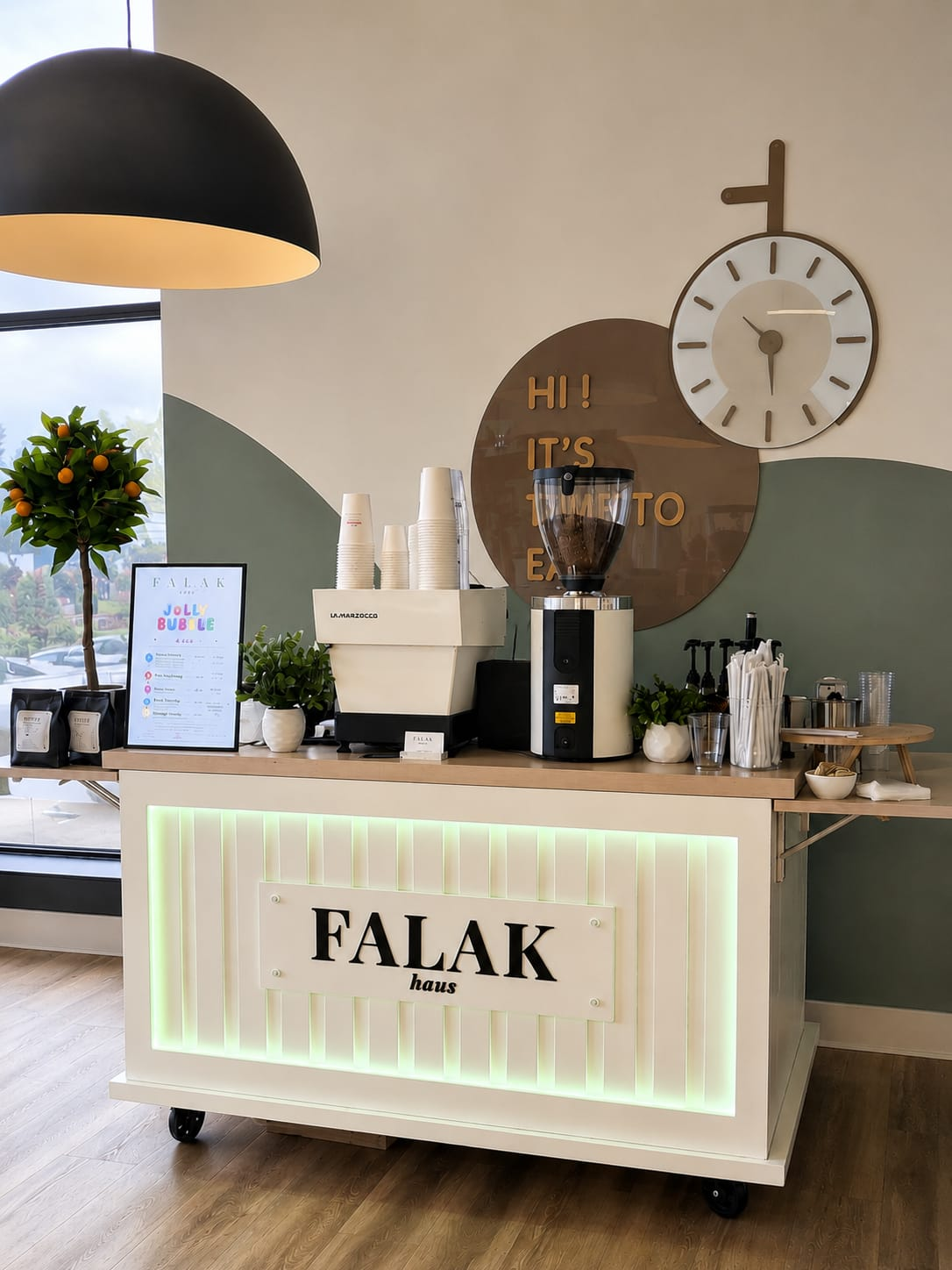 The Falak Haus coffee cart set up indoors with a La Marzocco espresso machine